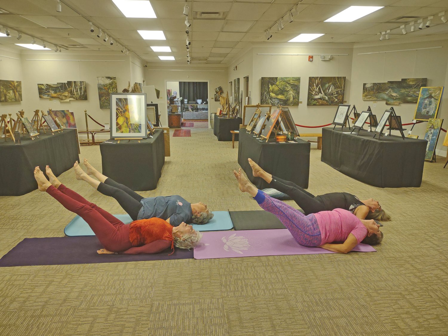 Yoga practioners - Nancy, Gaylin, Darla and Nancy Zachary - at the Peter Powell Roberts Museum demonstrate “Fish Pose.”
